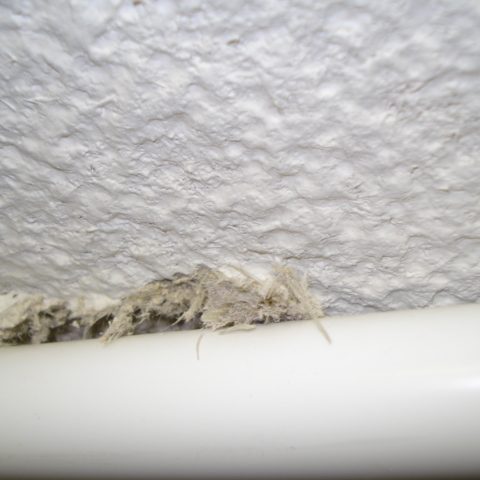 Spay asbestos to ceiling