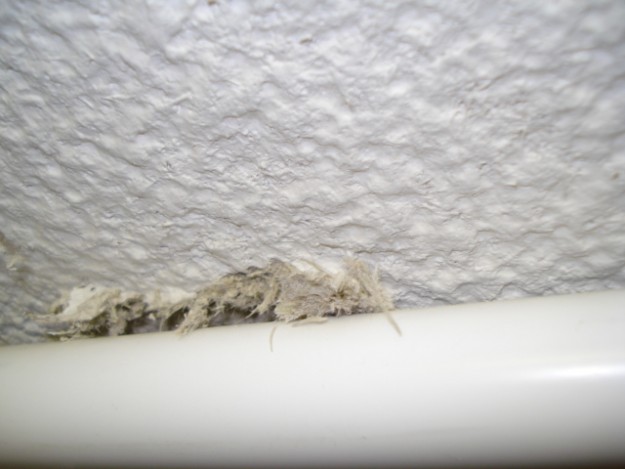 Spay asbestos to ceiling